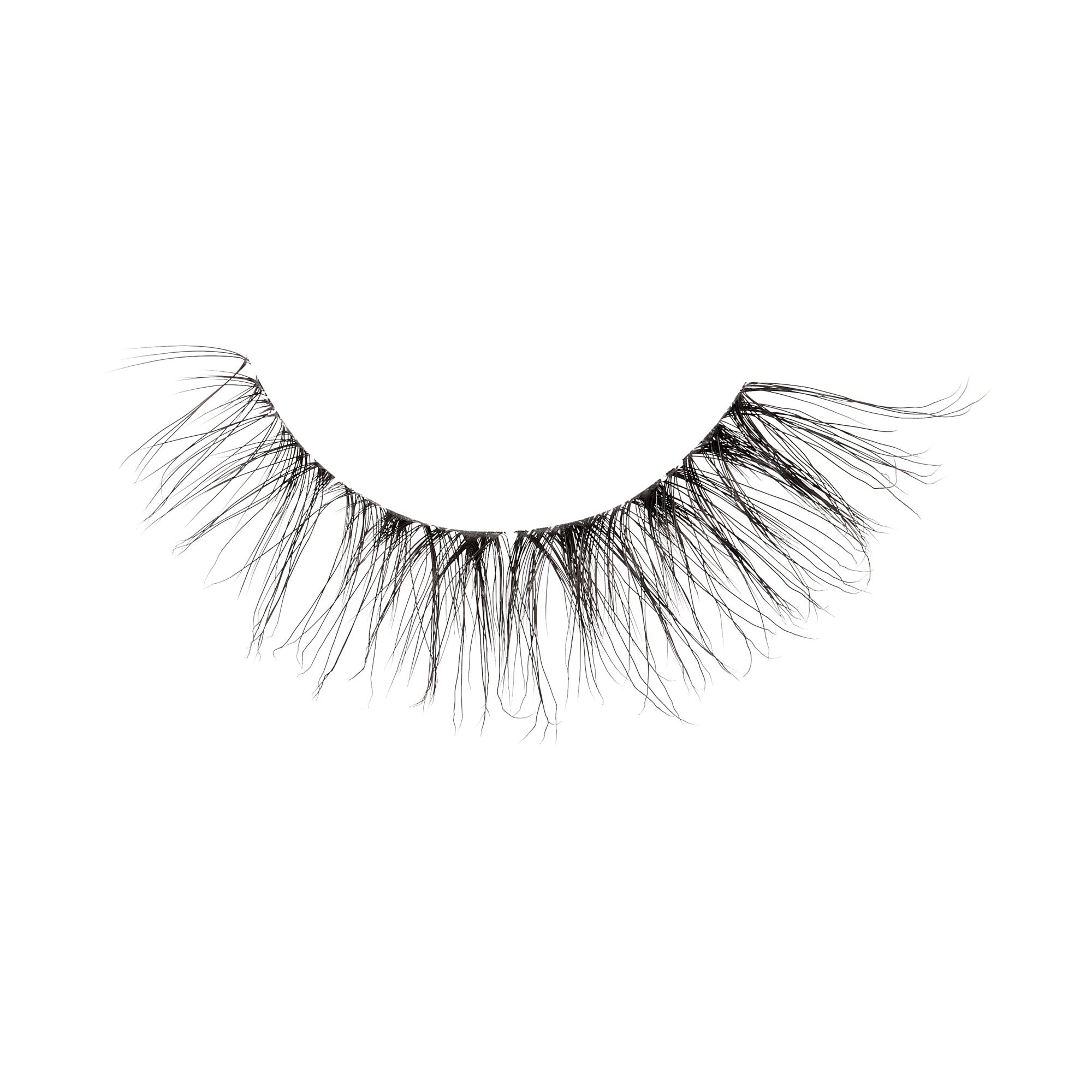 A single lash strip against a white background with a messy, lived-in look. False lash is by KISS Lash Couture Rebel collection in &